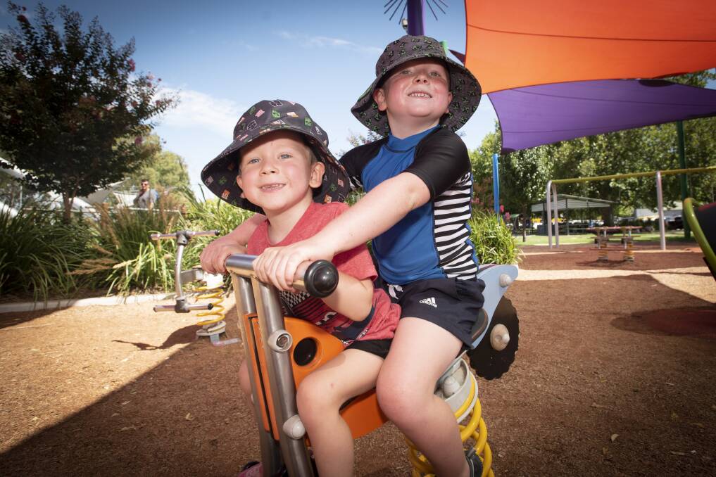 WARM WEATHER: Hilton and Kingsley Collins enjoyed the playground at a Tamworth park on the final day of January. Photo: Peter Hardin