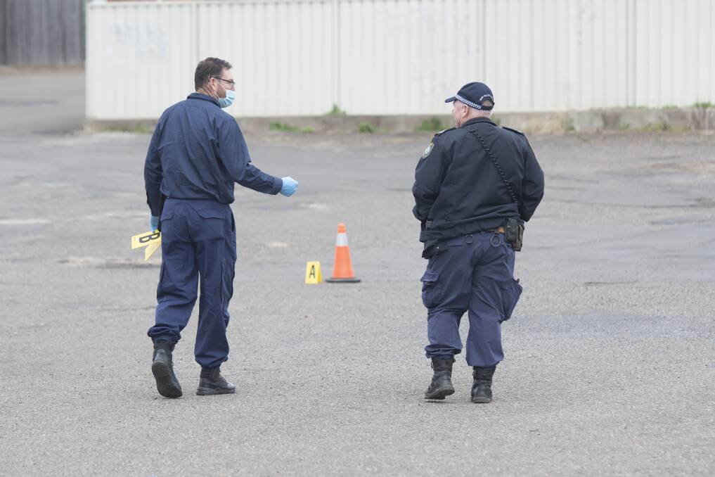 Police collect evidence from the crime scene in August, last year. Pictures by Peter Hardin
