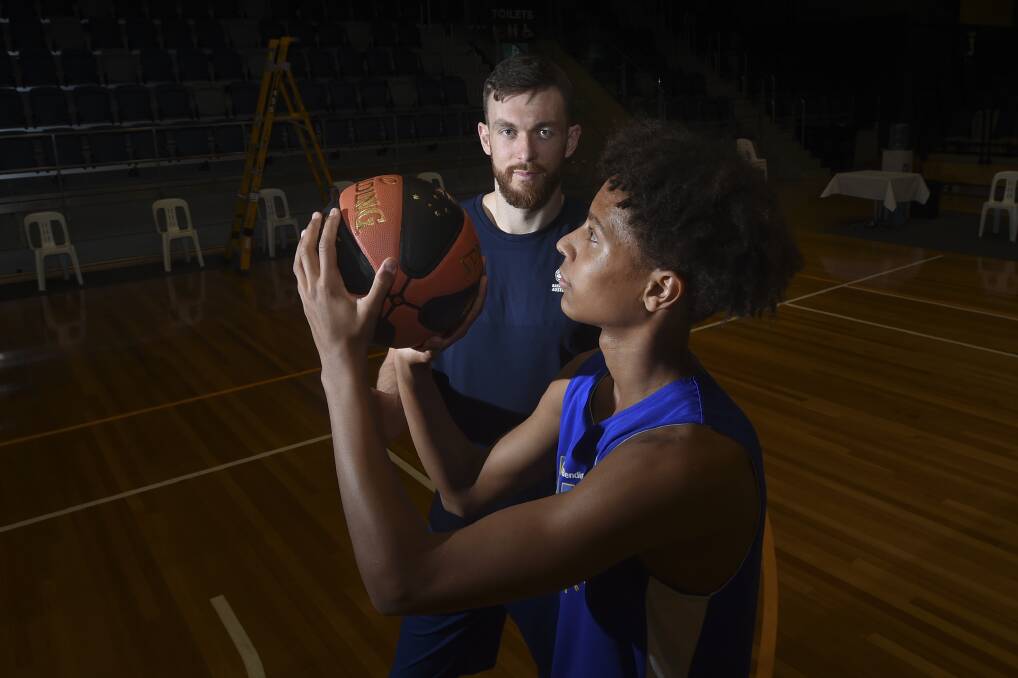Nick Kay shares a few pointers with local Bendigo player Dash Daniels ahead of the Boomers clash with Iran in Bendigo on Monday night. Picture by Noni Hyett