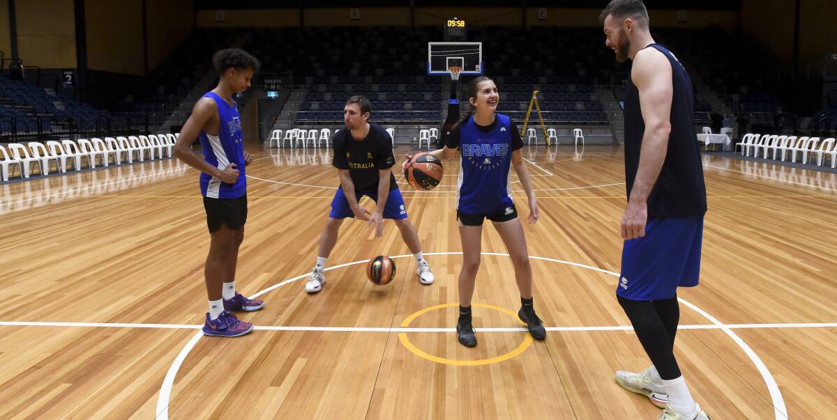 Nick Kay and Mitch McCarron taught Mia Harvey and Dash Daniels a few drills ahead of the match on Monday against Iran. Picture by Noni Hyett 
