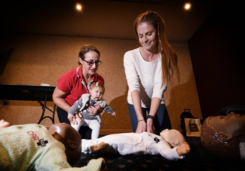 WELL PREPARED: CPR Kids trainer Allison Roberts teaches child resuscitation in the first Tamworth class with new mum Lily Single and baby Isla. Photo: Gareth Gardner