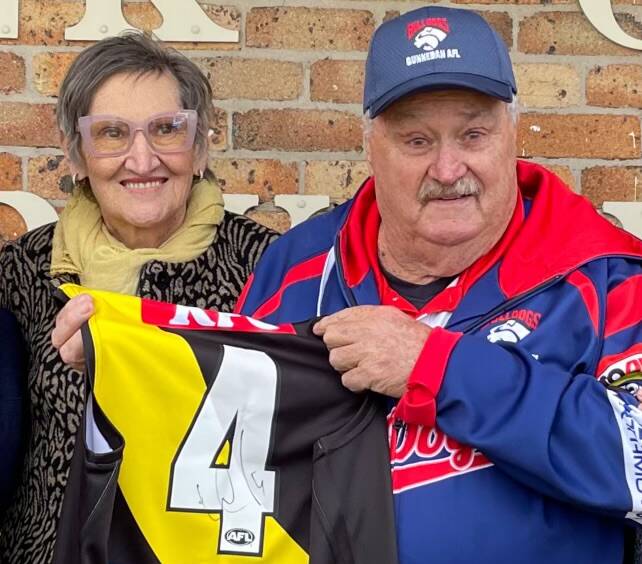 Brian Lenton, a lifelong Richmond Tigers fan, is emotional alongside Deb Naismith with the signed Dustin Martin jersey on Saturday. Picture supplied.
