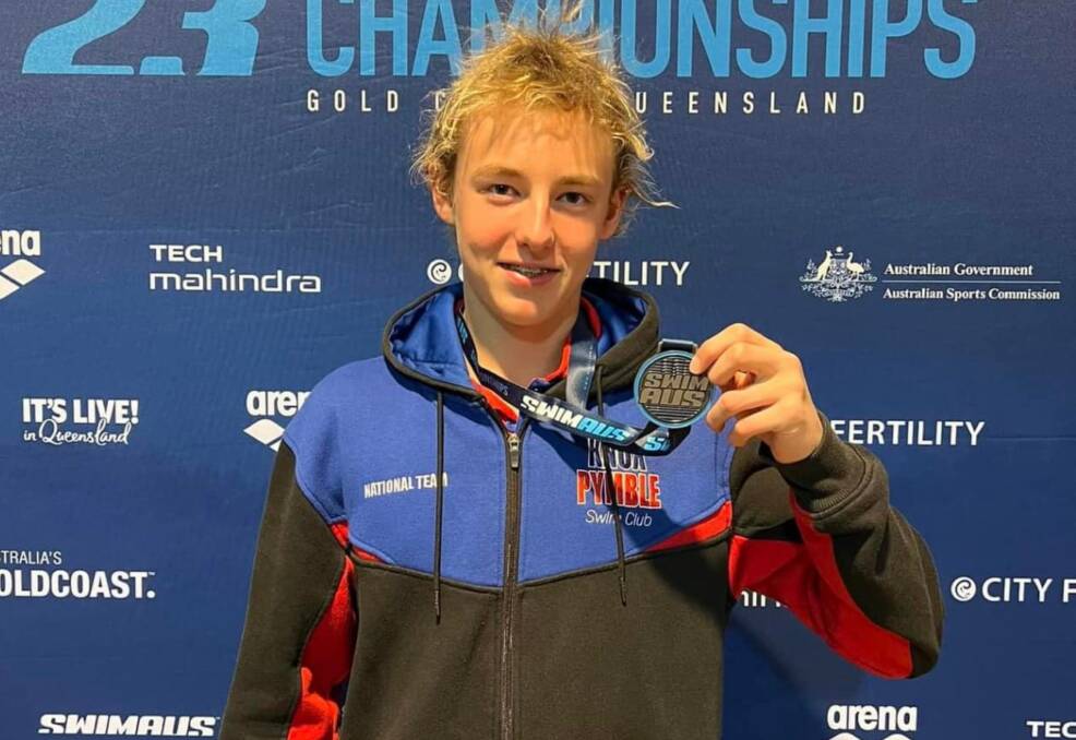 Jack Mitchell celebrates his silver medal in the individual medley relay last week, one of two that he picked up. Picture by Swimming New England and North West. 