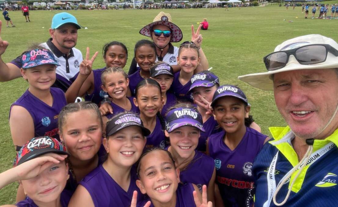 Tamworth Junior Oztag licensee, Bill Harrigan, with the under 11s girls team in Coffs Harbour over the weekend. Picture supplied.