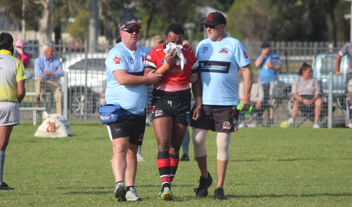 Marika Kuriyalavou is escorted from the field by trainers after having his jaw broken against Moree on Saturday. Picture by Zac Lowe.