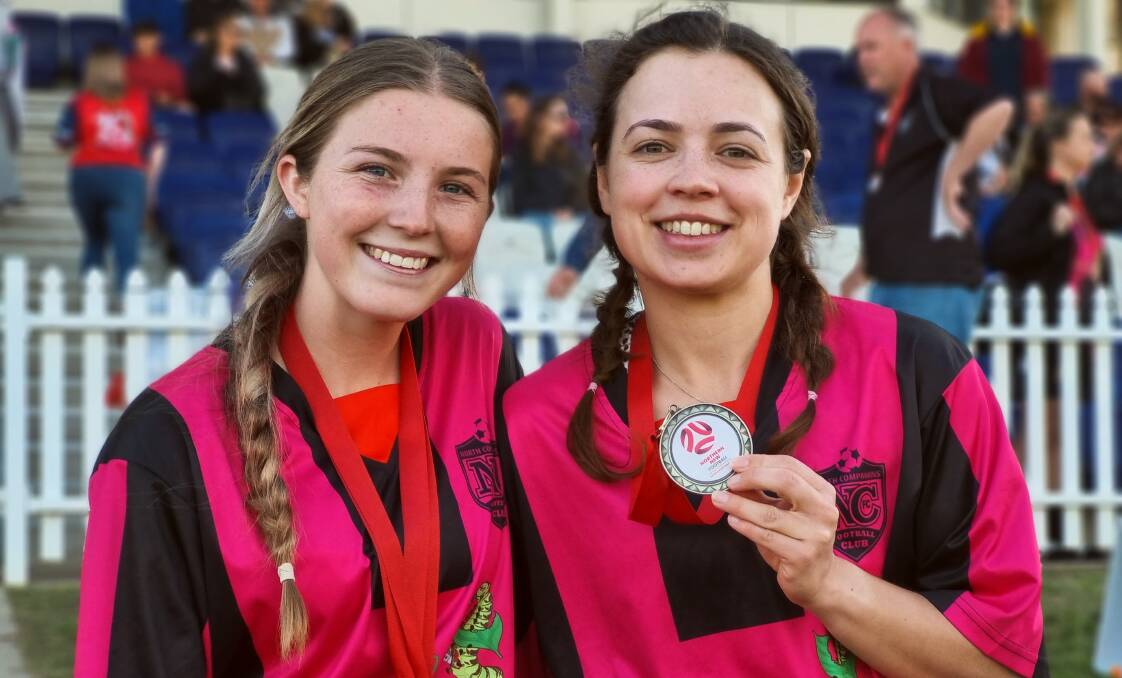 Michelle Clausen (right) with North Companions teammate Kayla Todd after their grand final win on Saturday. Clausen has come to see the club as a second family after six years in Tamworth. Picture by Zac Lowe.