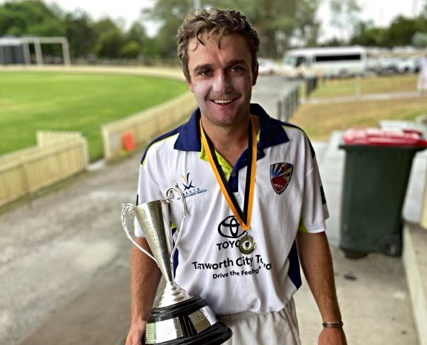 In a hurry to escape the rain and go celebrate with his team, Callum Henry can't wipe the smile off his face while holding the Connolly Cup. Picture by Zac Lowe.