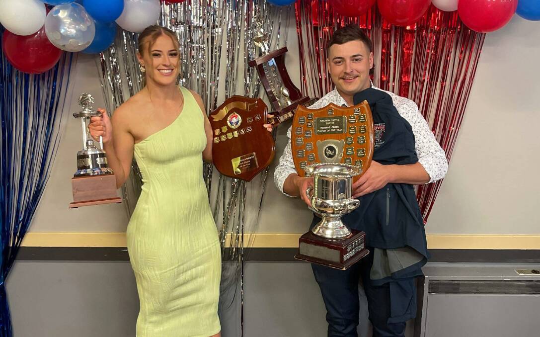 Piper and Tyrone Rankmore pose with just some of their many awards from the Gunnedah Bulldogs' presentation night. Picture supplied.