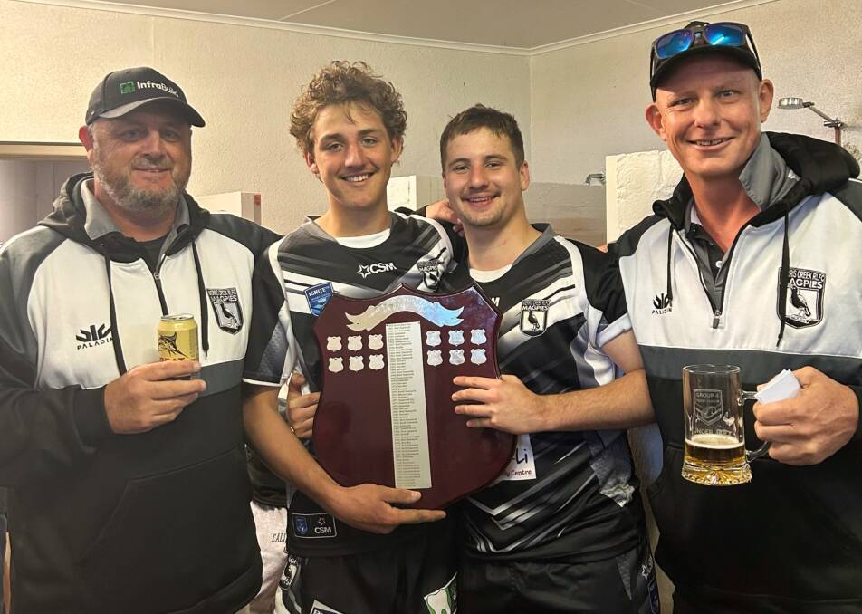 (From left) Neil Constable celebrates the premiership victory with his son, Parker, while Seb and Pat Lawler also shared in the team's success. Picture supplied.