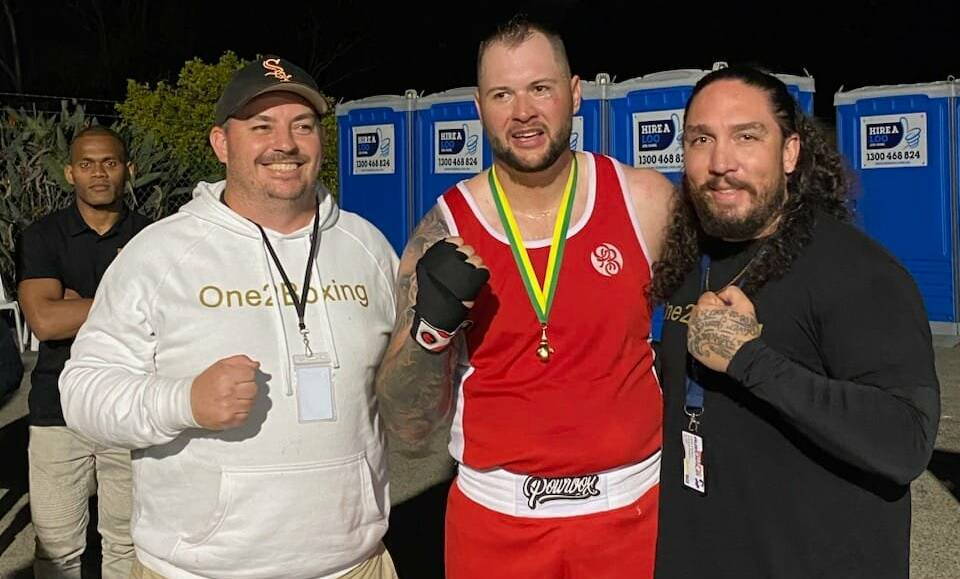 Denman celebrates his Golden Gloves title victory with coaches Jamie Carroll (left) and Anthony Rogers. Picture by One2Boxing Westside. 