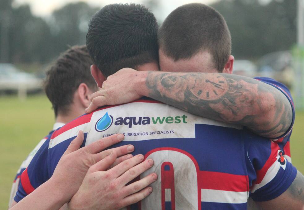 Smith embraces KC Edmonds after Gunnedah's hard-earned victory on Saturday. Picture by Zac Lowe.