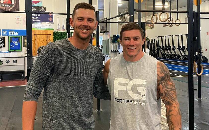 Josh Hazlewood and Jake Douglas remain close friends from their time at Oxley High School, and both have gone on to excel in their respective fields. Picture by Snake Athletic. 