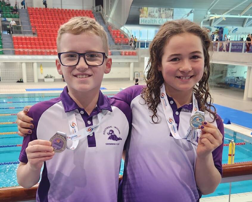 Thomas McDougall and Ruby Rule celebrate their enormous success at the recent Junior State Age championships in Sydney. Picture by Kootingal-Moonbi Swimming Club.
