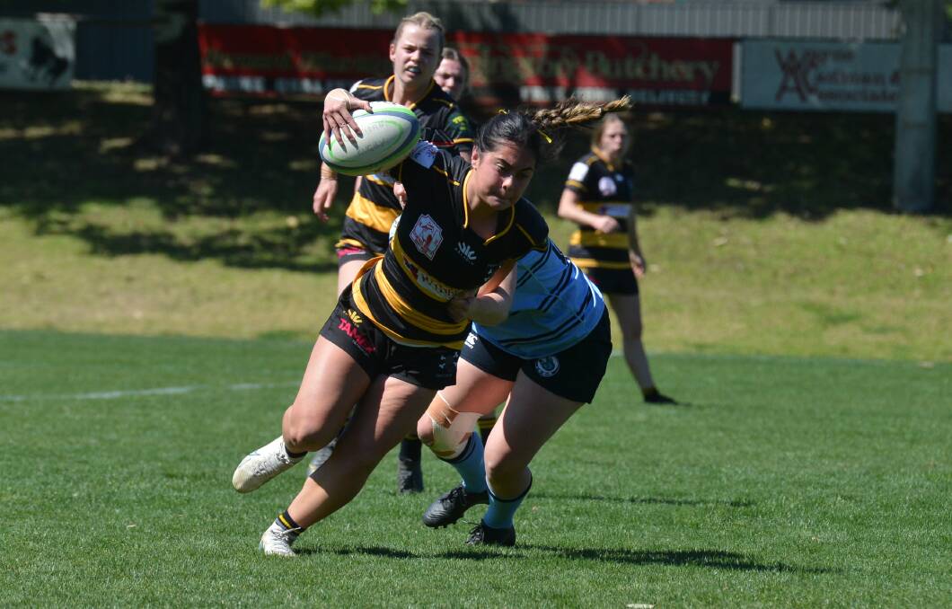 Pirates' Jayda Simpson is just caught by the Blue Boars defence. 
