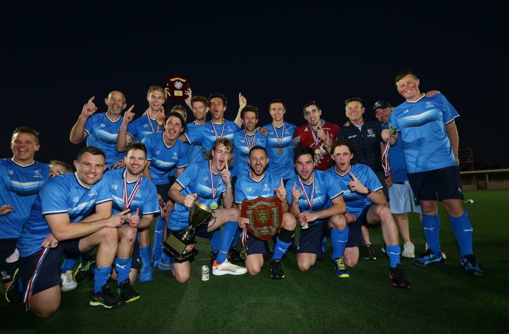 Tamworth's Sam Sam Liles (back fifth from right) and Tom Budden (far left) celebrate with their Norths team-mates after their thrilling grand final triumph. Picture by Jonathan Carroll