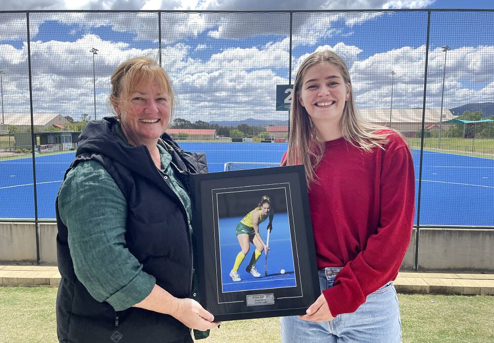 Alice Arnott (right) with Tamworth Hockey Association board member and former mentor Helen Willis, and the newest addition to the association's Australian representatives honour wall. 