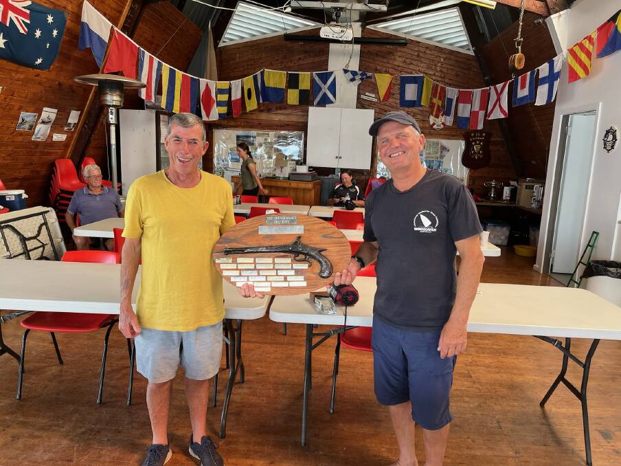 Lake Keepit Sailing Club commodore Tim Corben, happily receives the Olde Thunderbolt Trophy from New England counterpart Chris Thompson after their win on the weekend. Picture Supplied 