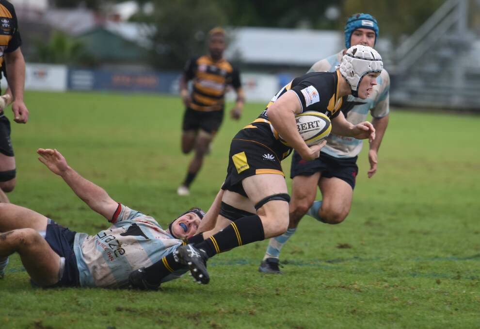 Quirindi outside centre Ben Grant clings to replacement Pirates back-rower Hamish McLaren.