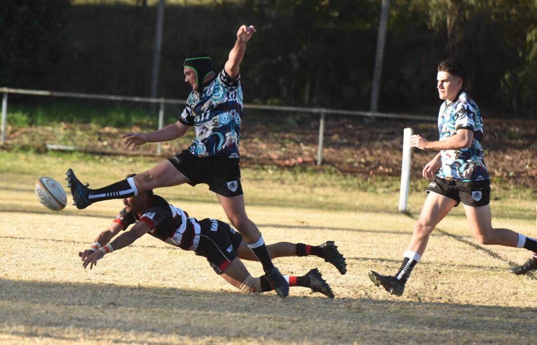 Brock Bayes' timely boot denies Barbarians' Edward Pitt a chip and chase try. Picture by Samantha Newsam