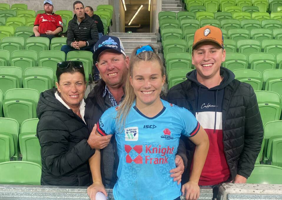 Brooke McKinnon is flanked by proud parents Lorraine and Rodney and boyfriend Dylan Walker after making her Waratahs debut.