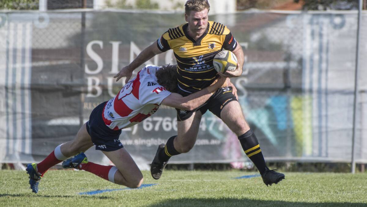 Pirates winger Sam Bowden is driven into touch by Walcha centre Ed Cordingley as Pirates threaten to break out of their half. Photo: Peter Hardin