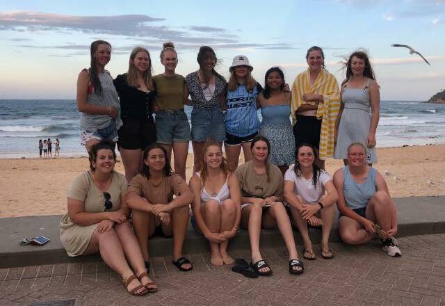 The North West softball girls enjoy some time at Manly beach.