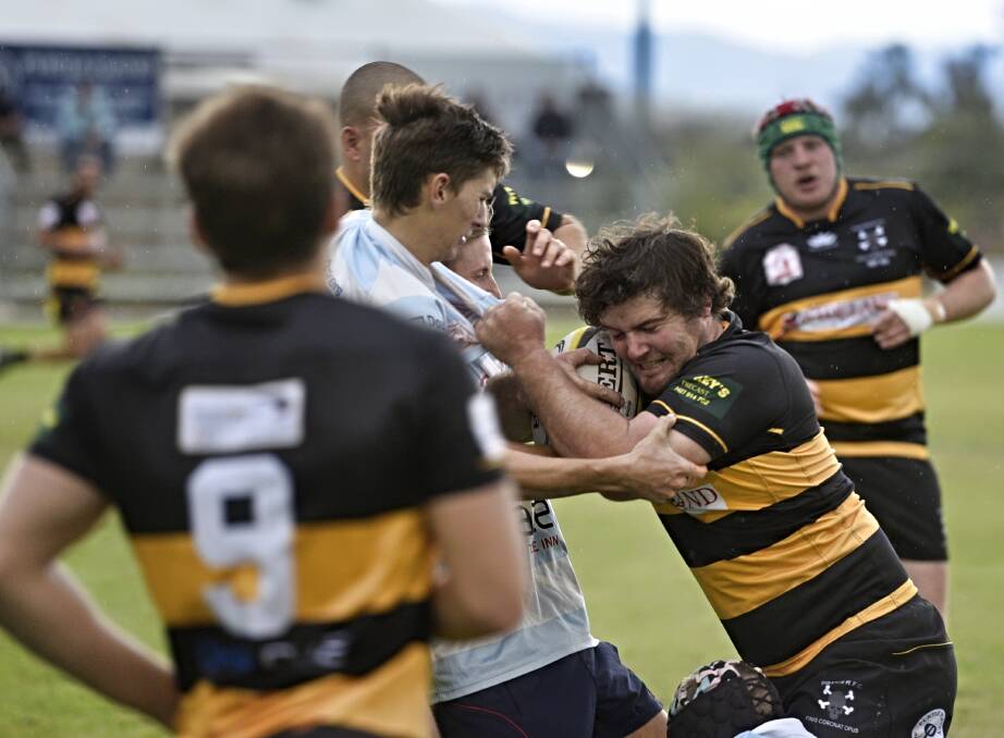 Pirates fullback Sam Collett is wrapped up by the Quirindi defence.