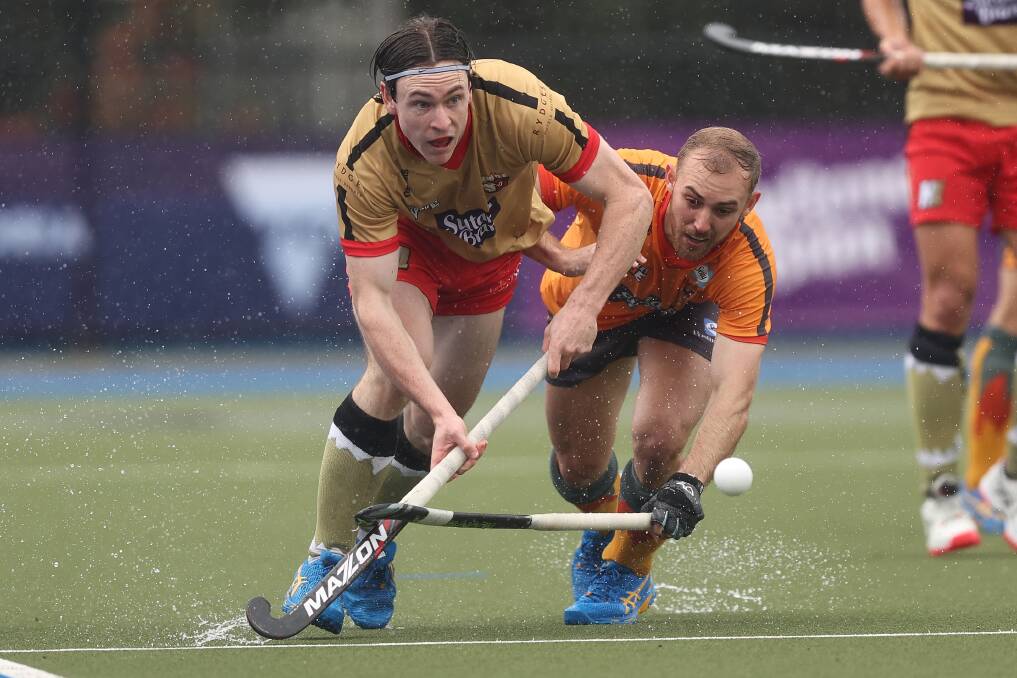 Armidale's Nathan Czinner competes for the ball against Jake Whetton during their Hockey One semi-final in Bendigo on Saturday. Picture Martin Keep/Getty Images.