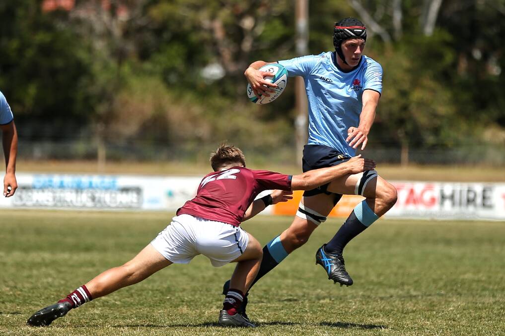 Lucas Broderick tries to slip past a Queensland opponent during last Sunday's under 15s clash. The Farrer student has far exceeded his expectations in making the NSW side. Picture PBS Sportspics