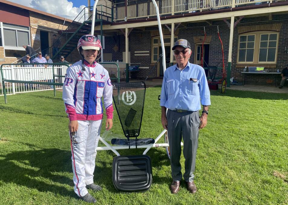 Prize bonus: Grace Panella and Armidale HRC President Peter Munsie, and the gig trophy, after she drove Western Ricki to the win in the Roberts & Morrow Accountants Armidale Gig Final. Photo: Julie Maughan