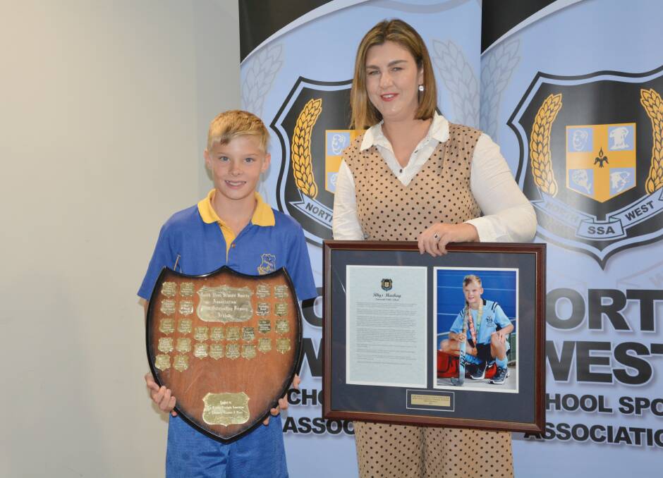 Rhys Mackay receives his Most Outstanding Primary athlete award from special guest, 2000 Paralympian Nicole Davey.