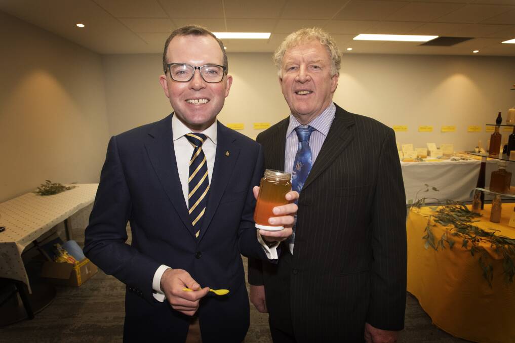 SWEET TREAT: Minister for Agriculture Adam Marshall and NSW Apiarists Association president Stephen Targett try some honey. Photo: Peter Hardin
