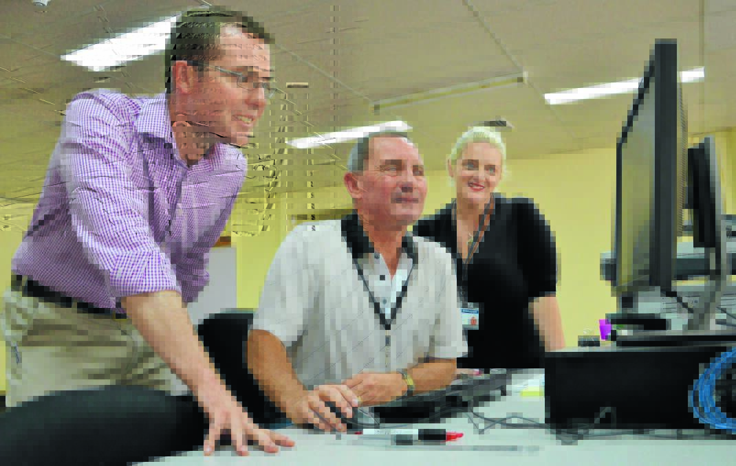 WINNERS ARE GRINNERS: Re-elected Northern Tablelands MP Adam Marshall watches on as returning officer Peter Dooley conducts a final count in front of witness Angel Harris.