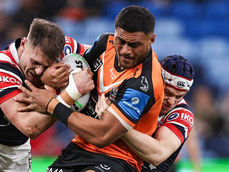 Giant prop Stefano Utoikamanu (c) has told Wests Tigers he's leaving after this NRL season. Photo: Mark Evans/AAP PHOTOS