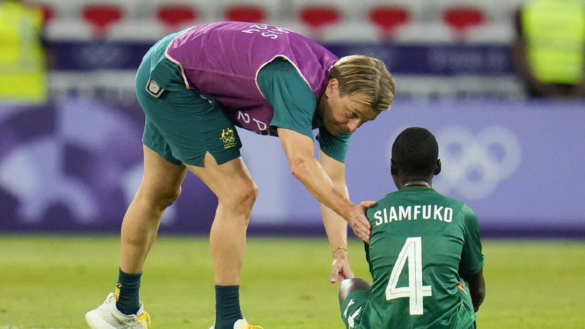 Australia coach Tony Gustavsson consoles Zambia's Esther Siamfuko after the match. (AP PHOTO)