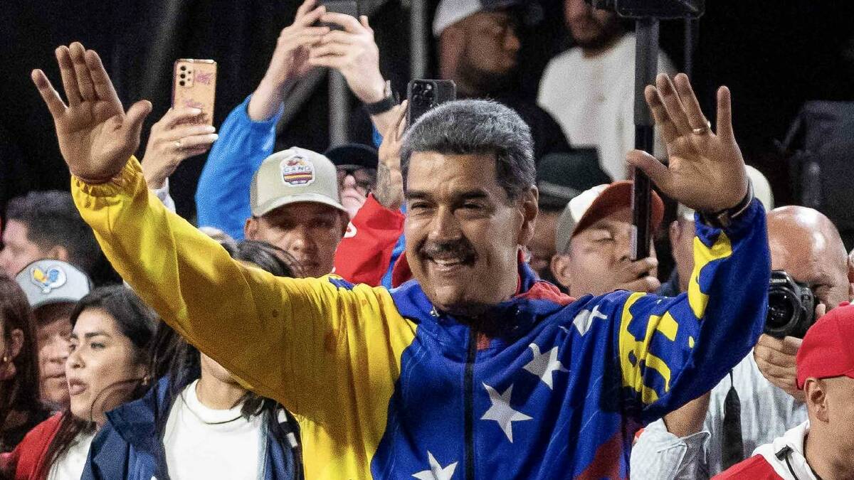 Venezuelan President Nicolas Maduro celebrates after announcing he won 51 per cent of the vote. (EPA PHOTO)