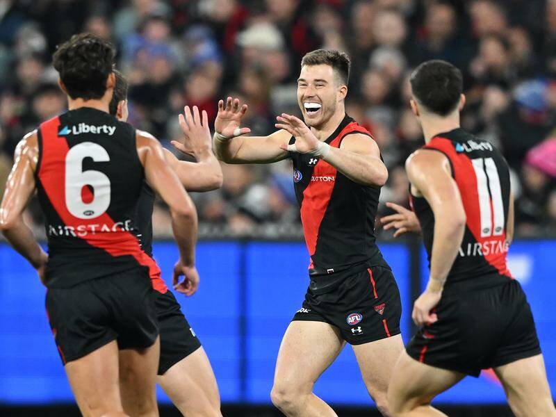 Zach Merrett (centre) has been pivotal in Essendon's rise to sixth on the AFL ladder. Photo: James Ross/AAP PHOTOS