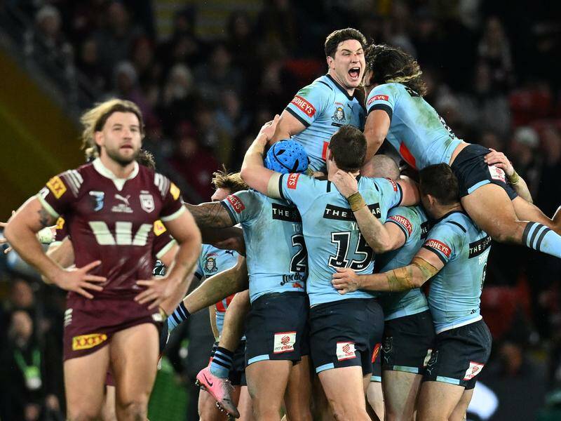 The Blues celebrate their series-clinching Origin triumph over the Maroons in Brisbane. Photo: Darren England/AAP PHOTOS
