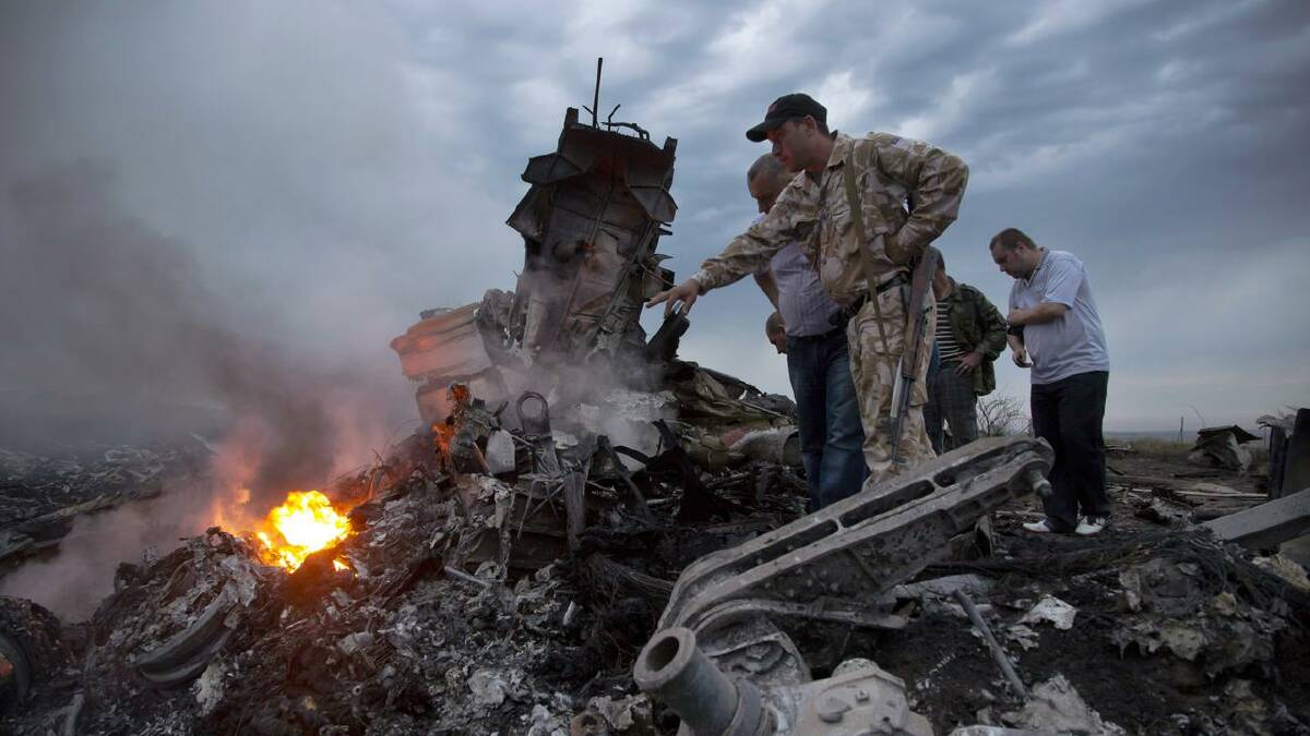 Tony Abbott has described the attack on flight MH17 as worse than a tragedy - it was an atrocity.  (AP PHOTO)