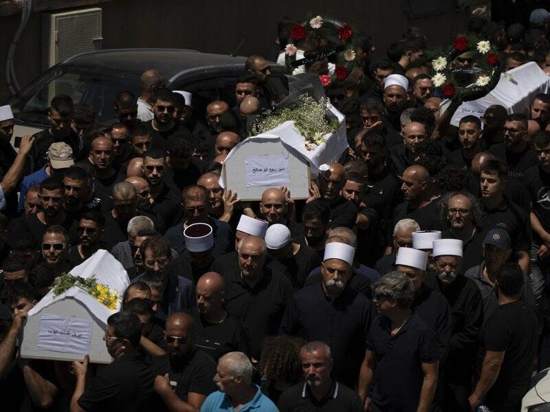 Thousands of Druze mourners gathered for funerals in the Golan Heights after a deadly rocket strike. Photo: AP PHOTO