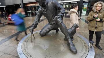 A statue of Matthew Flinders and his cat stands at Euston station near where his grave was found. (AP PHOTO)