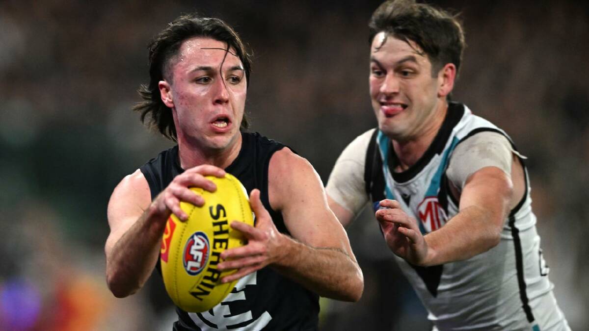 Port Adelaide's Zak Butters moves in to tackle Oliver Hollands of Carlton at the Marvel Stadium. (James Ross/AAP PHOTOS)