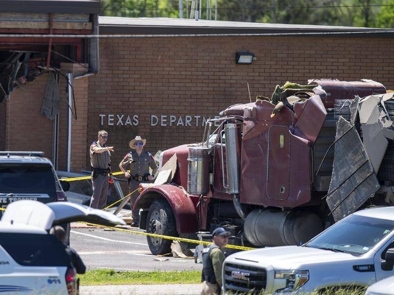 One person was killed and others injured when a driver rammed a semitrailer into their building. (AP PHOTO)