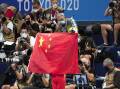 A Chinese flag is unfurled on the podium of a swimming event final at the Tokyo Olympics. (AP PHOTO)