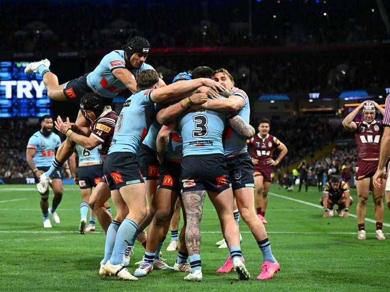 NSW celebrate Bradman Best's try in the State of Origin series-clinching win over Queensland.  Photo: Darren England/AAP PHOTOS