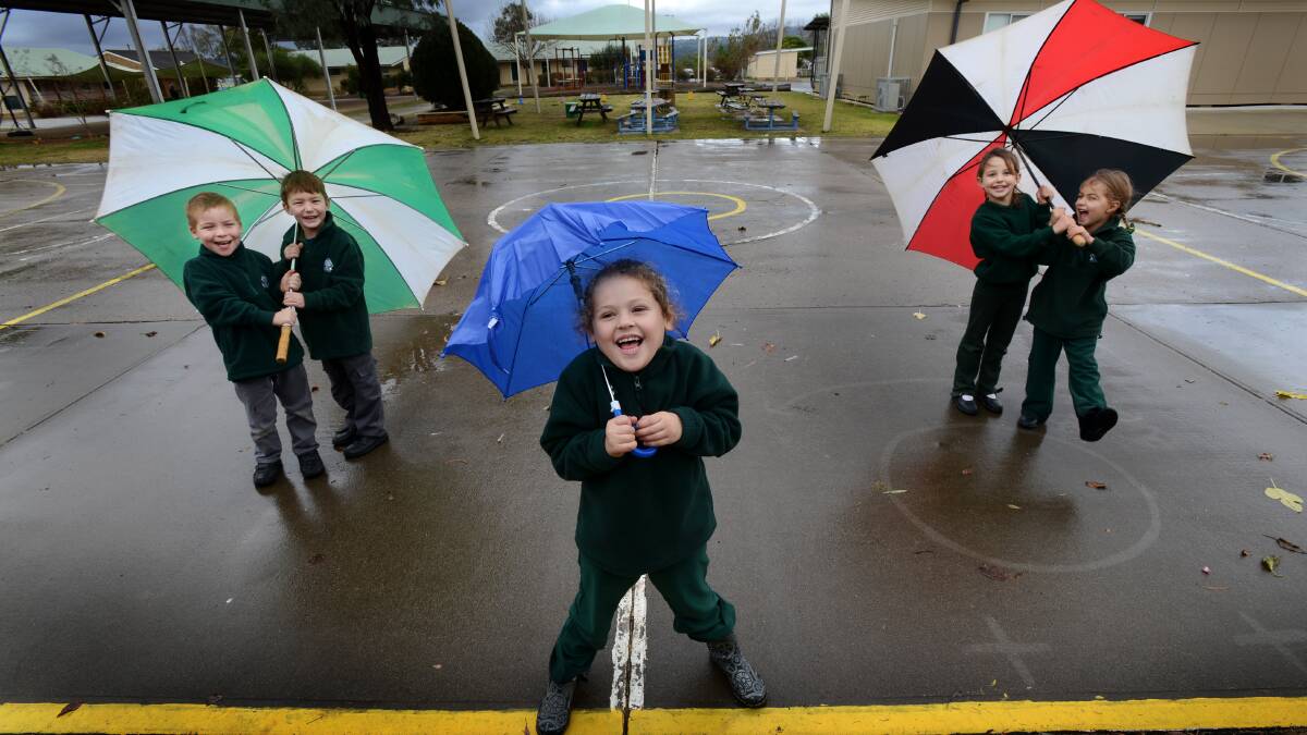 Kindergarten kids at Barraba Central School were soaking up the rain in June. Photo:Barry Smith 120613BSA02