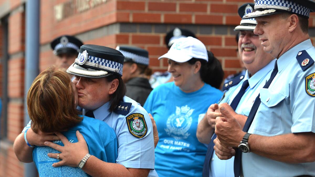 Tamworth police duty officer Inspector Kylie Endemi hugs the Fiona Rixon at the end of the her husband's memorial walk. Photo:Barry Smith 020313BSA33