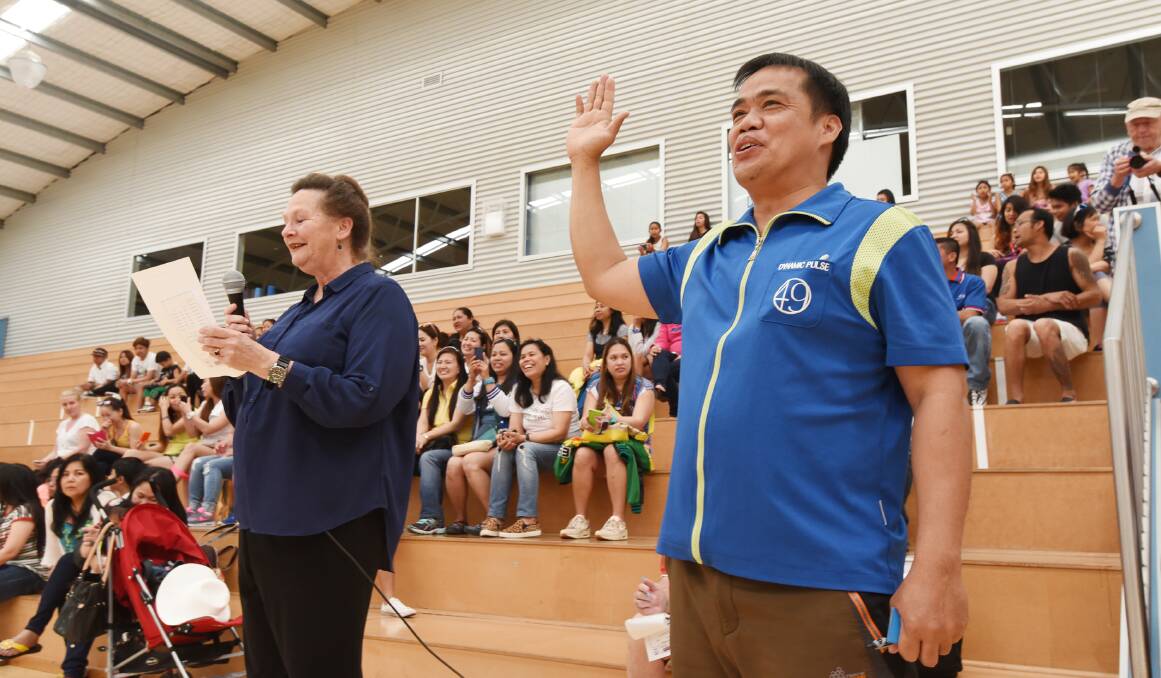 Tamworth Basketball Association president Michaelene Halpin reads out the players’ oath as  Pastor Inrico Orbe responds. Photo: Barry Smith 101015BSA09