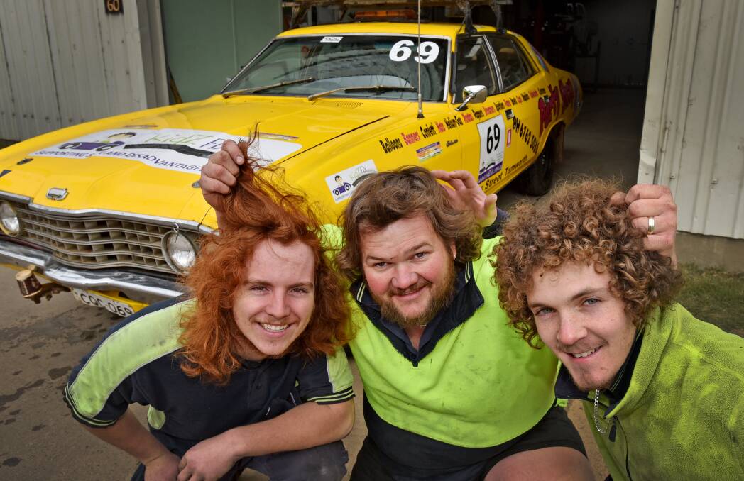 HAIR-ERASING EXPERIENCE: Curry & Gleeson mechanics Luke Struck, Shane Gleeson and Matthew Hellman are looking 
forward to losing their locks and raising a few more dollars 
tomorrow. They’re pictured with charity bowls day organiser Ian Alford’s KidzFiz rally Fairlane. Photo: Geoff O’Neill 130815GOA01