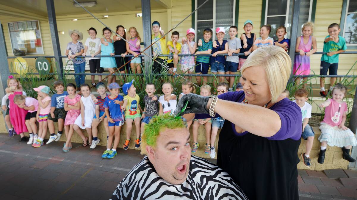 GREEN GLORY: Willow Tree Public School principal John Ireland has his hair dyed by local hairdresser Cate Hewett. Photo: Barry Smith 110316BSD05